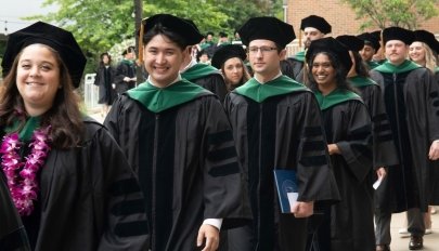 Graduates walking in a line outside