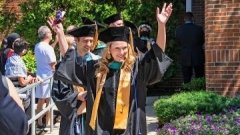 graduate raising hands with joy