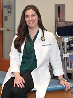 Dr. Boburka profile picture in white lab coat in a physician assistant setting with equipment.