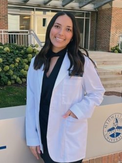 Profile photo of Occupational Therapy student Mckenzie Pflaum in a white coat.