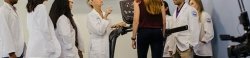 Students and faculty working with patient walking on a treadmill.