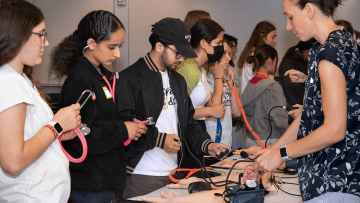 High school students use stethoscopes during the PharmAcademy event.