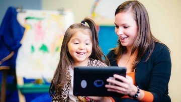 Child learning to read on an tablet