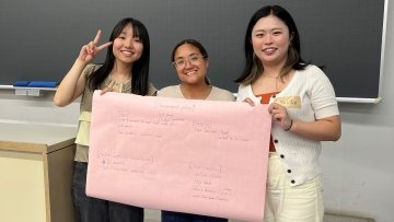 Pharmacy student Bethany Jimenez holds poster of collaboration.