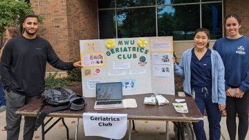 Geriatrics Club poses by their club poster at the Organization Fair.