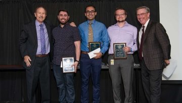 Students holding their awards