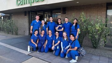 Optometry students pose for a group photo outside the Community Foundation building.