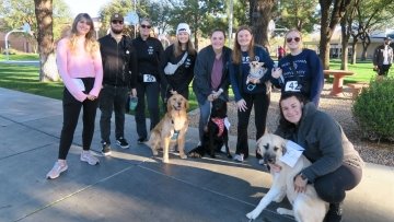 Midwestern community runs with their dogs in the Pup Strut race.