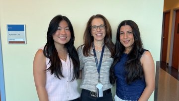 Student Lauren Aniceto, Faculty Cindy Krizizke, and Student Saya Albonaimi stand in a row. 