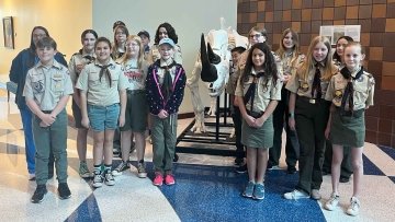 Group of Local Scout Troup Standing Near Rhino Skeleton.