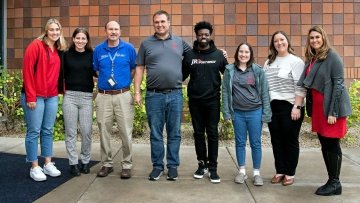 Students standing with faculty