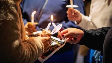 Students lighting candles during the Mahsa Amini Memorial Vigil.