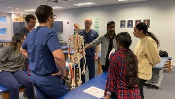 High School Students looking at a skeleton