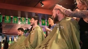 Students and faculty getting heads shaved.