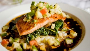 Salmon dish with broth and veggies.