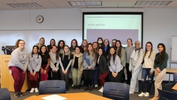 SLP group gathers for a classroom photo.