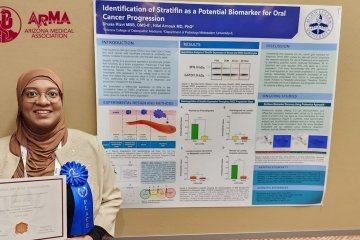 Shuaa Rizvi in front of her poster, won first place at Arizona Medical Association 