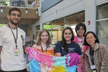 Pharmacy students make no-sew blankets and display their handiwork.