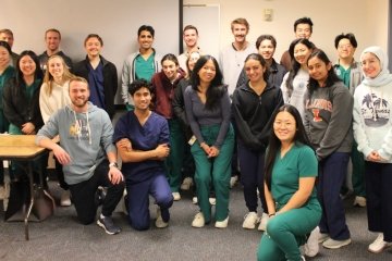 Medical students attend the lifestyle medicine talk, gather for group photo.