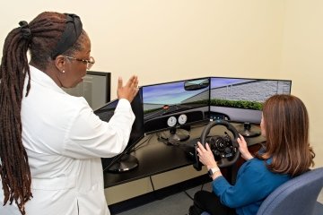 Dr. Wright explains the simulation program to one of the participants.