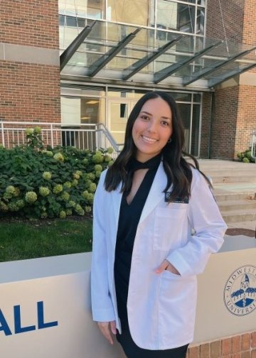 Profile photo of Occupational Therapy student Mckenzie Pflaum in a white coat.