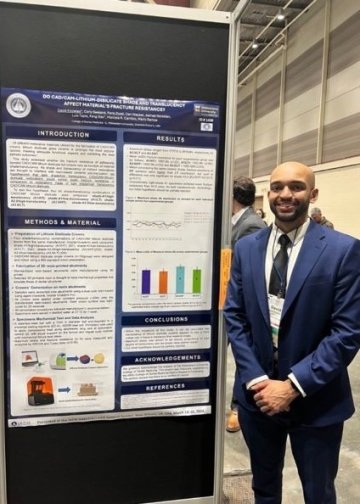 Dental student David Knowles in front of a research poster. 