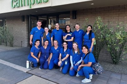 Optometry students pose for a group photo outside the Community Foundation building.