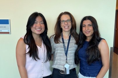 Student Lauren Aniceto, Faculty Cindy Krizizke, and Student Saya Albonaimi stand in a row. 