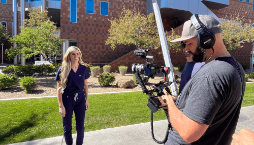 Megan Beard being filmed by cameraman at the Midwestern University Arizona campus.