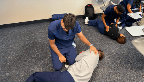 Participants in the opioid overdose prevention training sessions work in pairs to administer naloxone.