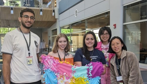 Pharmacy students make no-sew blankets and display their handiwork.