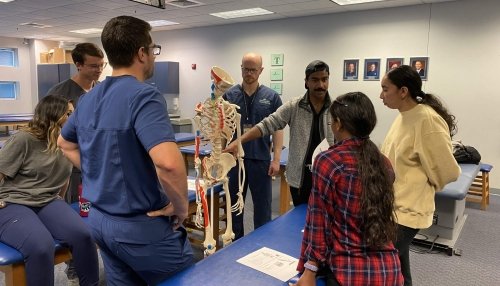 High School Students looking at a skeleton