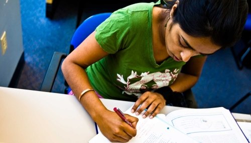 Student studying with a textbook