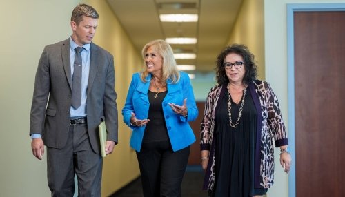 Nursing faculty walking down a hallway on the Glendale campus