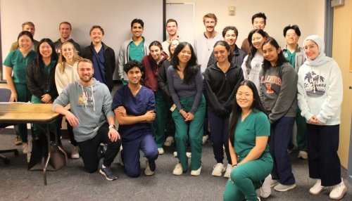 Medical students attend the lifestyle medicine talk, gather for group photo.