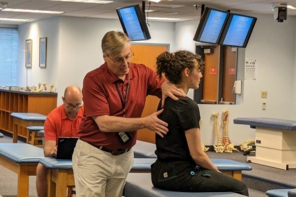 Dr. Heinking demonstrates OMM techniques to the visiting osteopaths.
