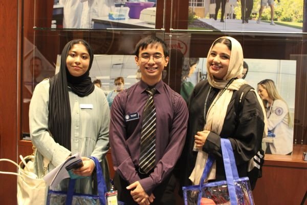 Pharmacy students attend the CareerEXPO and carry bags with information from recruiters.