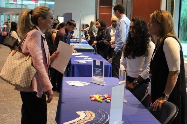 Pharmacy students meet with recruiters at their tables during the CAREERxPO.