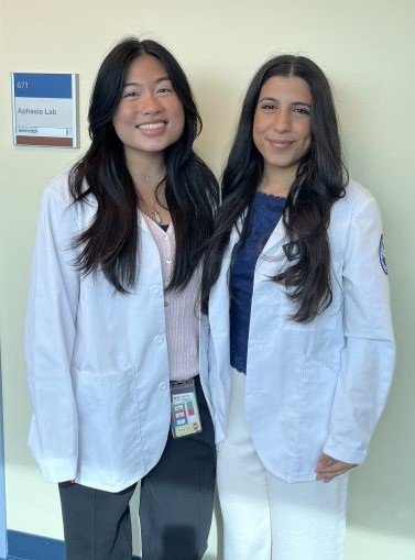 Lauren Aniceto and Saya Albonaimi in their white coats.