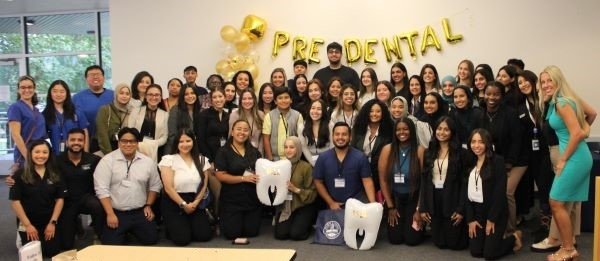 ASDA Pre-dental Day Group photo, students and attendees gather under the pre-dental balloons.