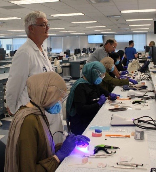 Dr. Williams supervises attendees in the dental simulation lab.