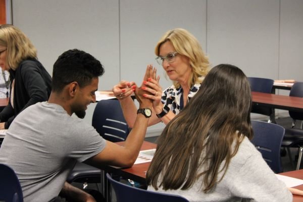 Dr. Lingle examines a student for hypermobility and pinch and grip strength.